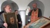 Georgia -- A man carries a portrait of former Soviet dictator Josef Stalin during a service marking the 57th anniversary of his death in a church in his hometown Gori, 05Mar2010